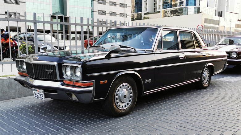 An H250 Nissan President in black, front 3/4 view