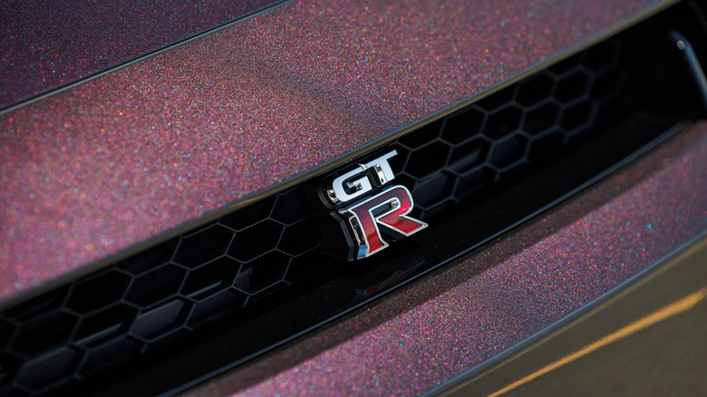 A close-up of the GT-R badge on an R35 in Midnight Purple