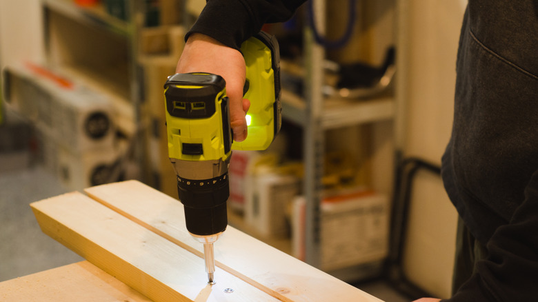 Person using a cordless drill