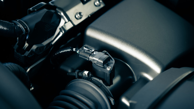 A close up shot of the mass air filter sensor in the engine bay of a car.