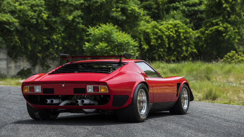 1974 Lamborghini Miura SVR parked in front of green woods, rear-right 3/4 view