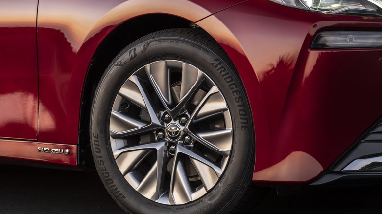 Close-up of front-right wheel of a red 2023 Toyota Mirai.