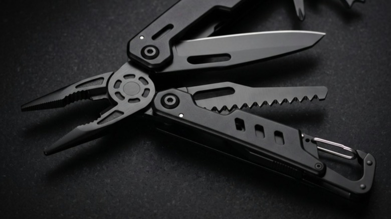 Blackjaw multitool unfolded on a dark stone surface
