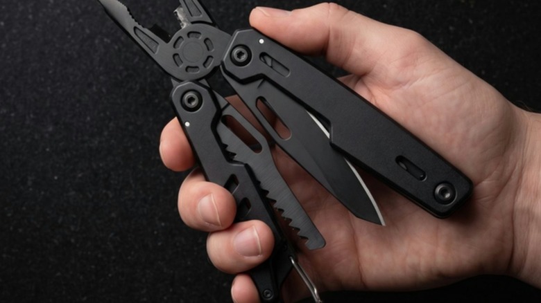 Hand holding the open Blackjaw multitool