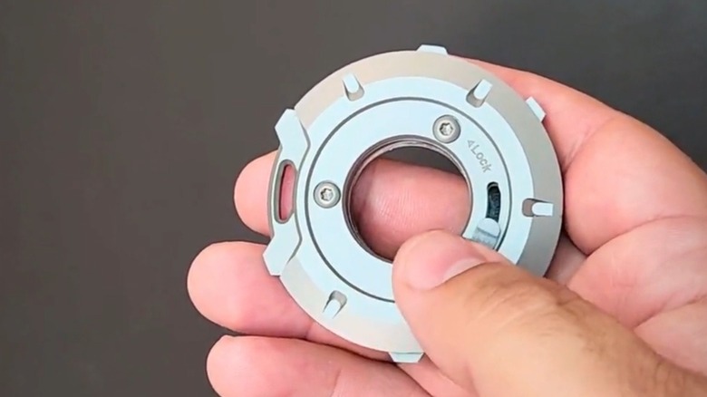 A person holding the GEO multitool with tabs visible for single hand operation