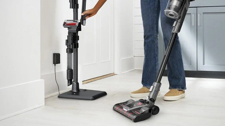 Woman charging Hoover vacuum