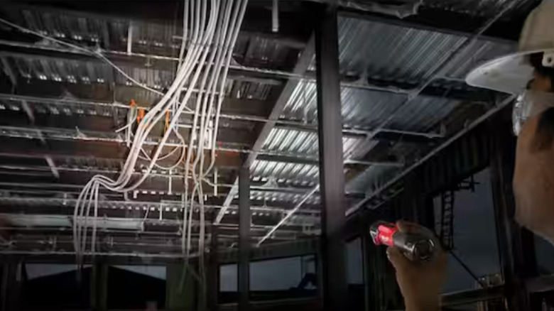 Milwaukee flashlight being used in dark room