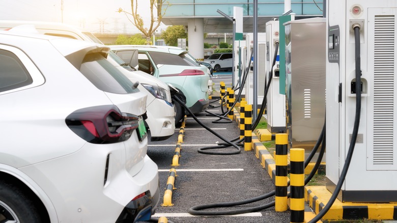 Several EVs plugged in at a charging station