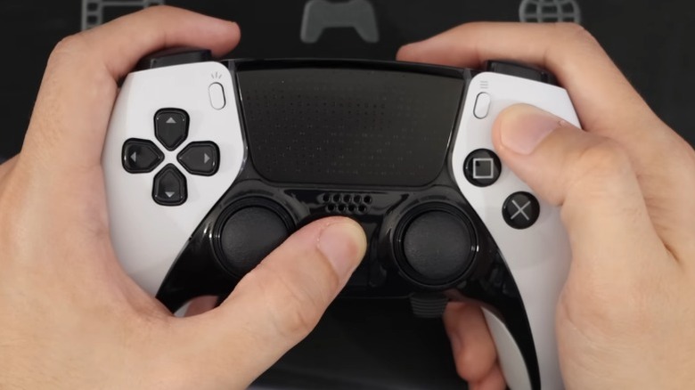 Mystic holding PS5 DualSense