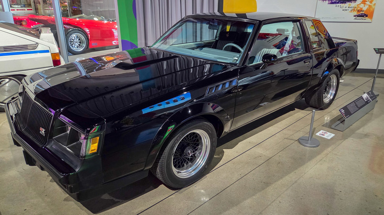 Front 3/4 view of black Buick GNX on display in car museum.
