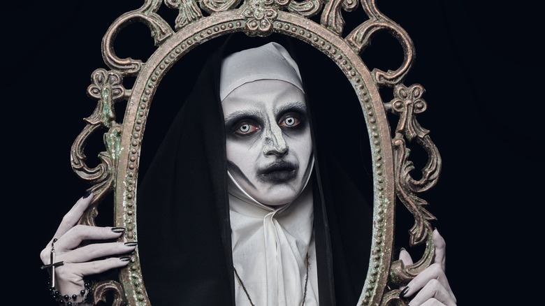 creepy nun with picture frame