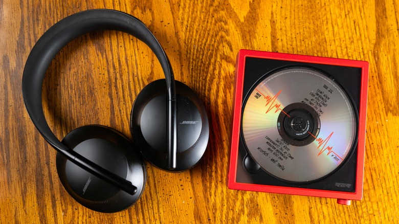 The Bose NC700 headphones next to the FiiO DM15 R2R with Pearl Jam's Gigaton album loaded into the CD tray.