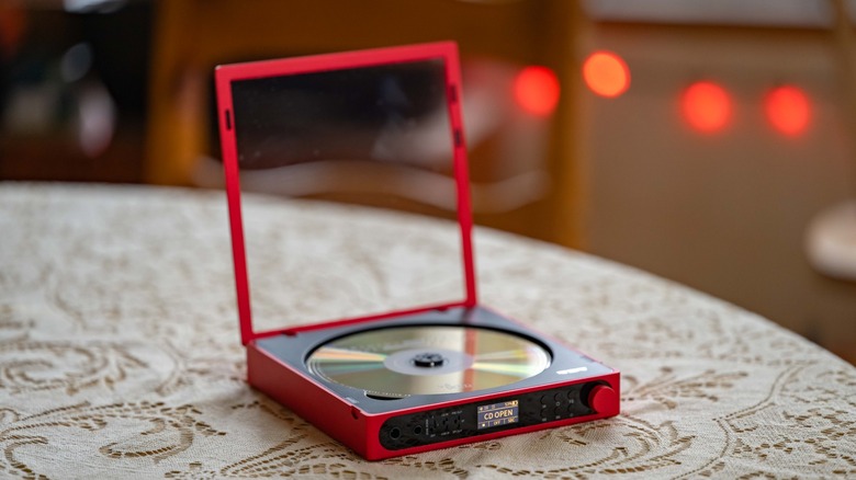 The FiiO DM15 R2R on a lace tablecloth with the lid open.