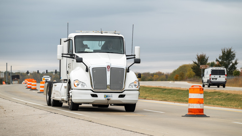 Electric semi-truck driving on charging highway