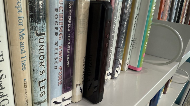 Oukitel WP300 amongst books on shelf.