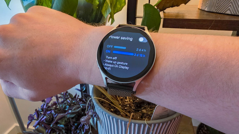 Samsung Galaxy Watch7 on a person's wrist showing power saving screen