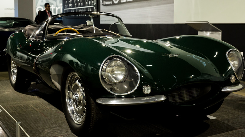Green 1956 Jaguar XKSS displayed indoors
