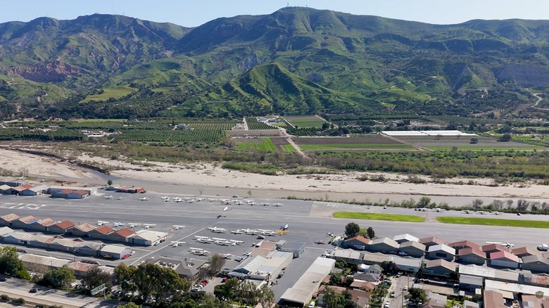 An aerial shot of the Santa Paula Airport with farmland and mountains in the background