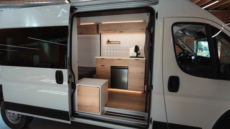 Sliding door opened to show the kitchen in a Hunker Pod campervan