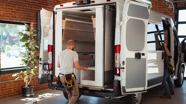 Fitters installing the Hunker Pod into a van
