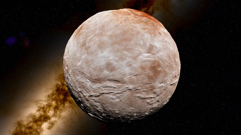 Picture of pluto with a hint of the Milky Way galaxy in the background.