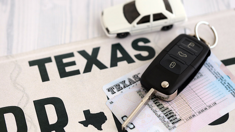 Car key fob, car model, and driving license on a Texas plate