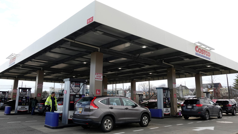 Vehicles have their gasoline tanks filled at a Costco Wholesale store