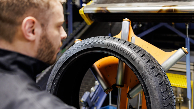 Tire technician checking a Continental tire