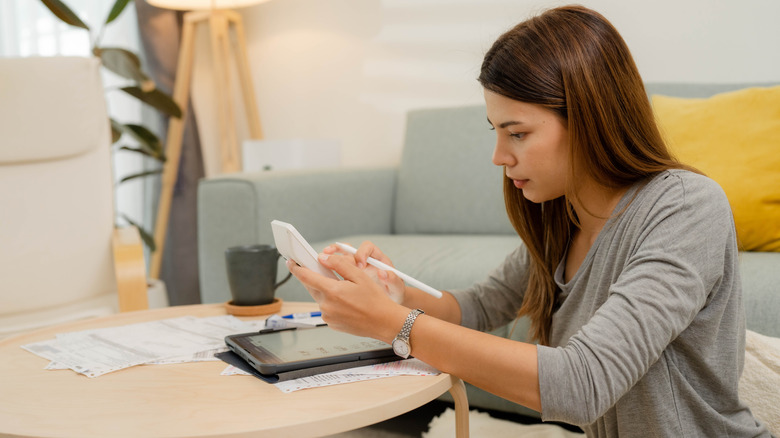 Person using a small desk calculator