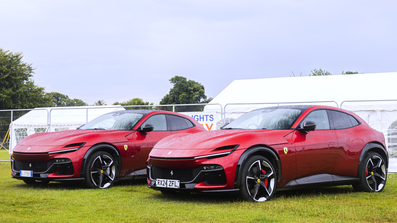 A red Ferrari Purosangue parked in a field
