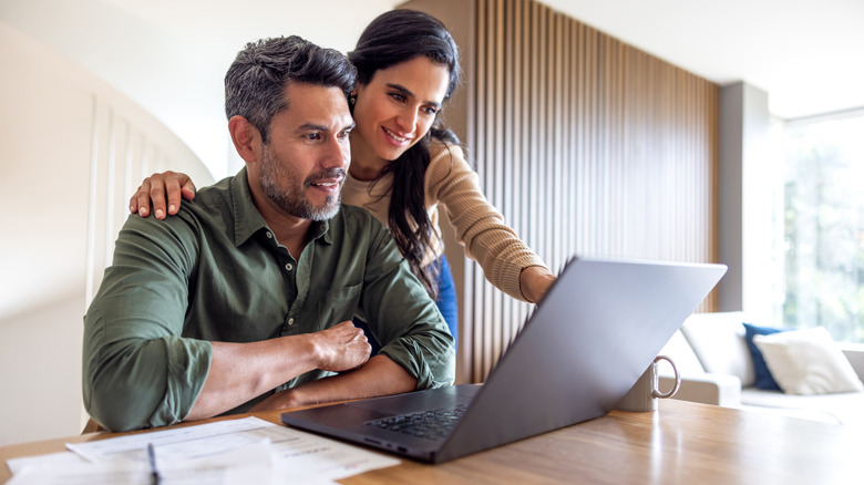 A couple looking at a laptop