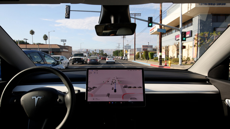 Tesla view from backseat as it drives without driver on road