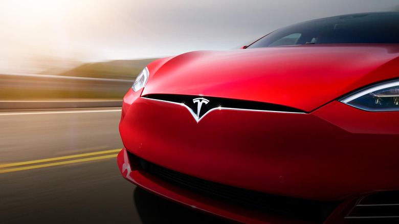 red tesla model s driving