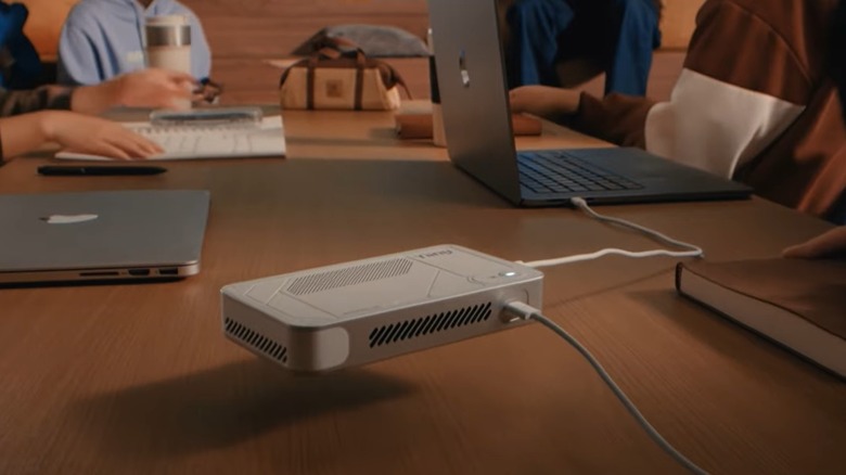 AI Pocket Lab shown "floating" above a desk and connected to a laptop
