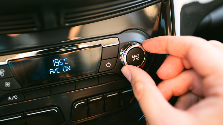 Driver turning on the air conditioning