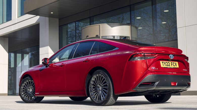 Rear shot of a red 2021 Toyota Mirai in-front of a city building