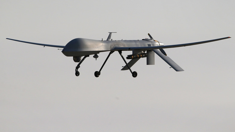 An unmanned drone carrying a Hellfire missile