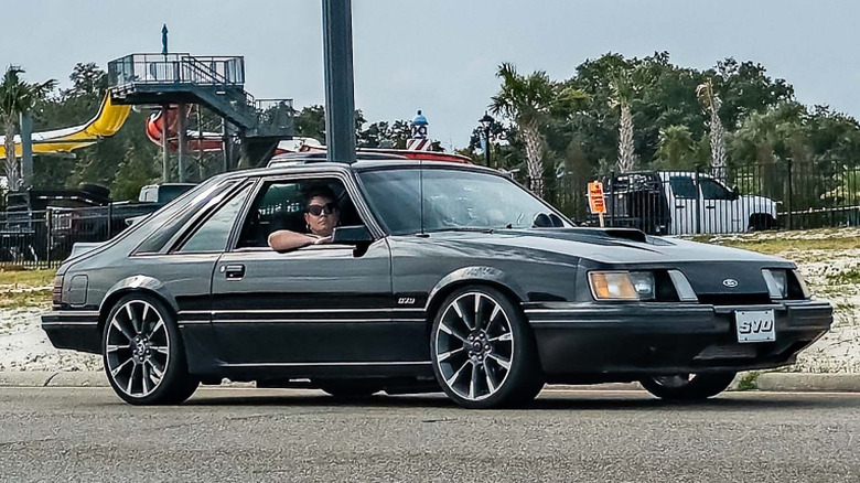 Ford Mustang SVO in Dark Sage, cruising through Gulfport, Mississippi