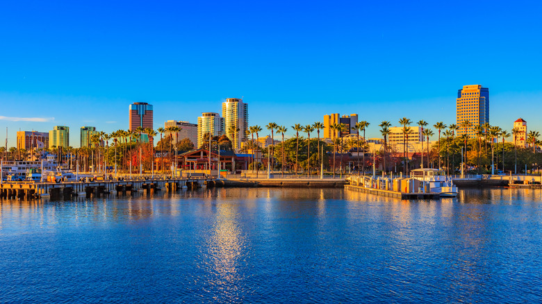 Large letters spell out the name Long Beach along a stretch of highway with the city in the background