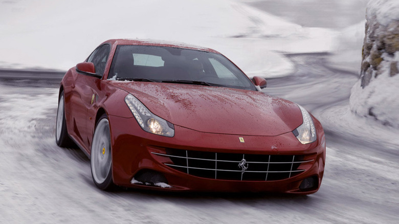 Front 3/4 view of Ferrari FF driving on snowy winding road