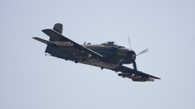 Douglas A-1 Skyraider "The Proud American" in flight over the show.
