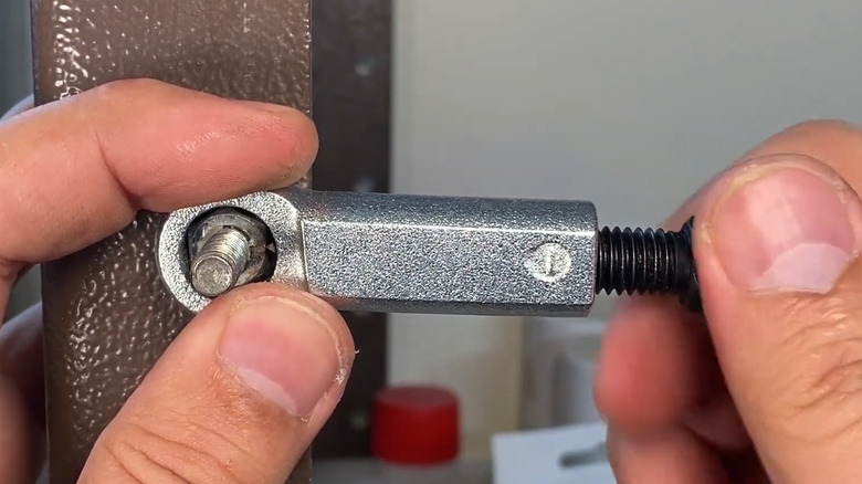 Nut splitter tool being used on bar
