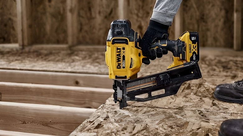 Person using DeWalt nail gun on floor