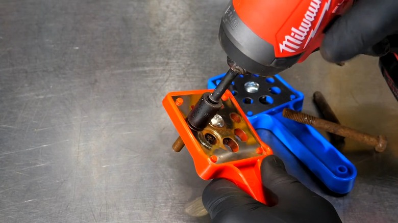 A Thread Wizard bolt cleaner cleaning a dirty fastener