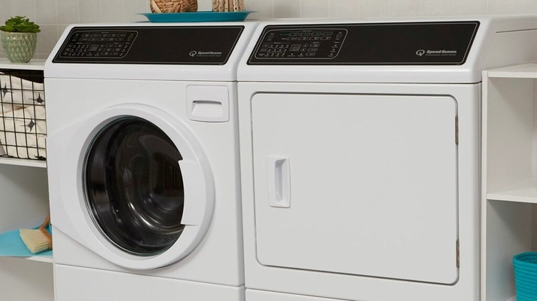 A Speed Queen FF7 washing machine next to a DF7 dryer in a laundry room