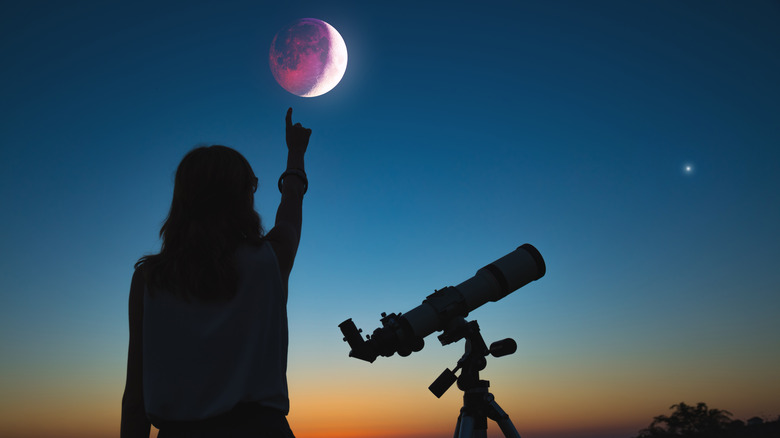 Girl watching a lunar eclipse.