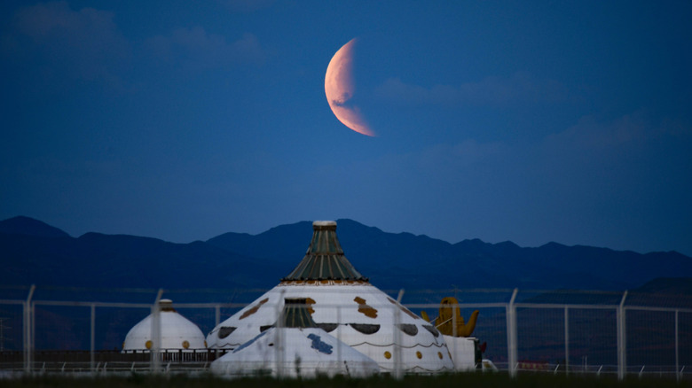 Lunar eclipse over buildings