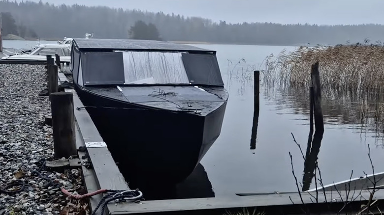 The solar yacht docked in a lake in wintertime
