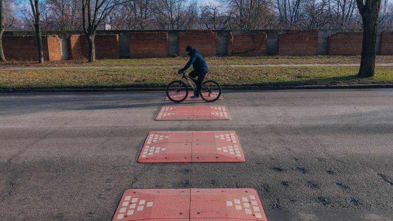 A cyclist going through a gap in a speed cushion