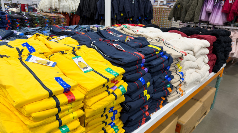 Stacks of clothes at a Costco outlet.
